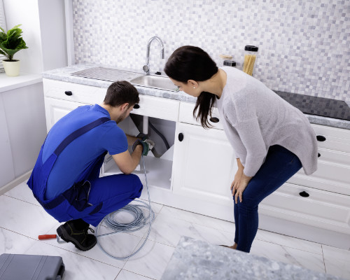 Plumber-Cleaning-Clogged-Sink