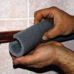 Straight Shooter technicians wrapping water lines with insulation