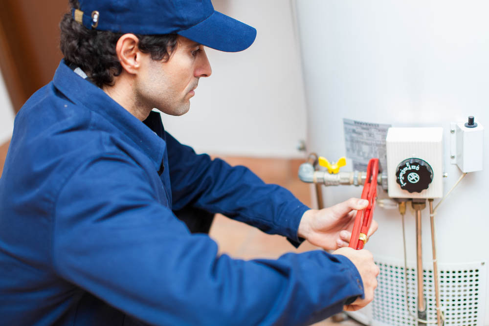 Straight Shooter technician servicing a water heating system
