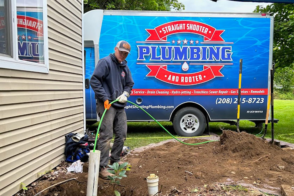 Plumber hydro jetting a sewer line