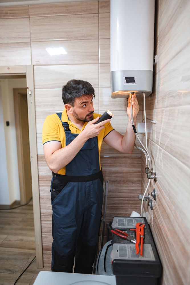 plumber inspecting water heater